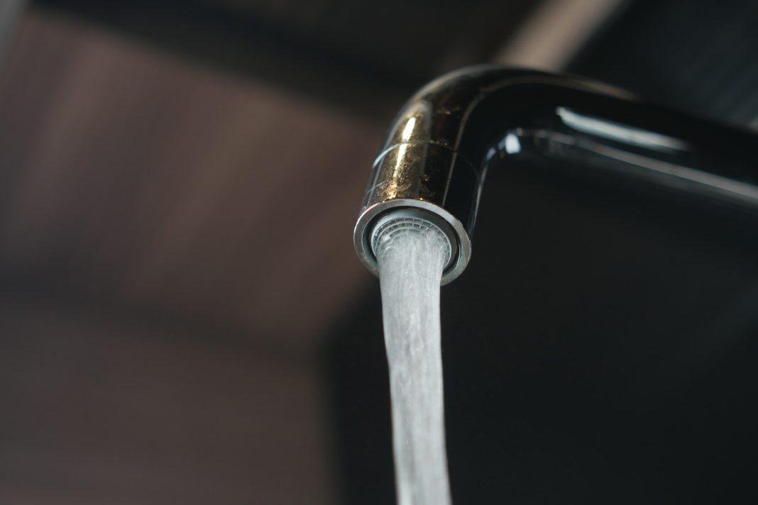 close up of faucet with flowing water