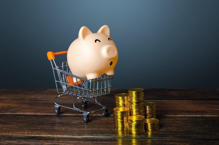 Piggy bank surprised by stacks of coins.
