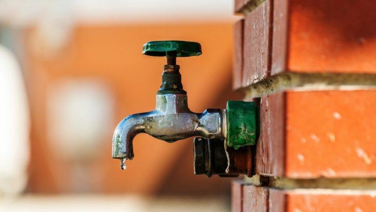 Water supply, outdoor garden faucet with green handle